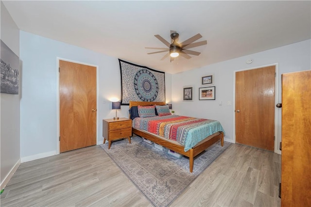 bedroom with ceiling fan and light hardwood / wood-style flooring