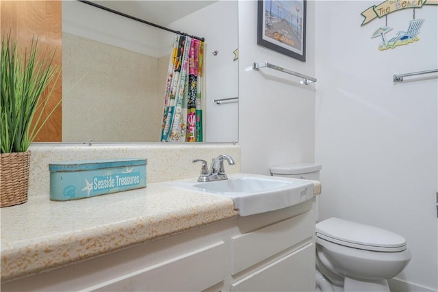 bathroom with vanity, walk in shower, and toilet