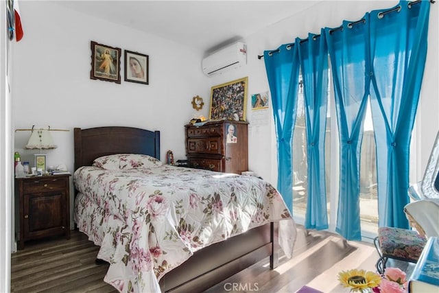 bedroom featuring access to exterior, dark wood-style flooring, and a wall mounted AC