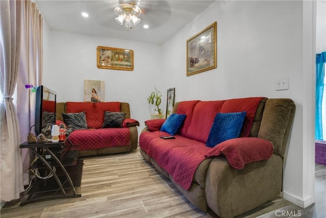 living room featuring recessed lighting, baseboards, ceiling fan, and light wood finished floors