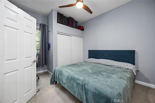 carpeted bedroom with a closet and ceiling fan