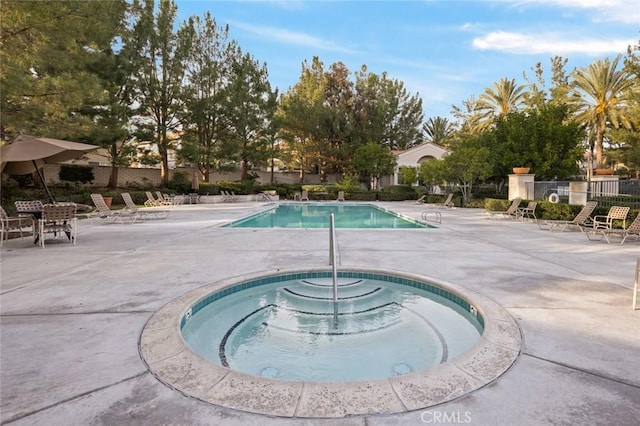 view of pool featuring a patio area and a community hot tub