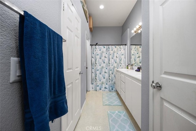 bathroom with vanity and curtained shower