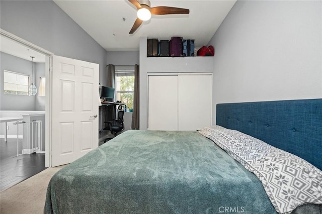 bedroom with ensuite bathroom, lofted ceiling, and ceiling fan