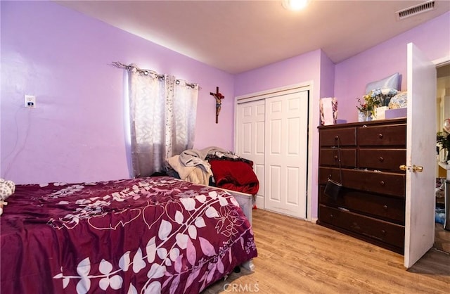 bedroom featuring light hardwood / wood-style floors and a closet