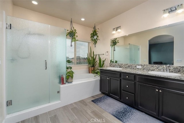 315 Timberline Way S, Madera, CA 93636 - bathroom with a bath, double vanity, a stall shower, and wood finished floors