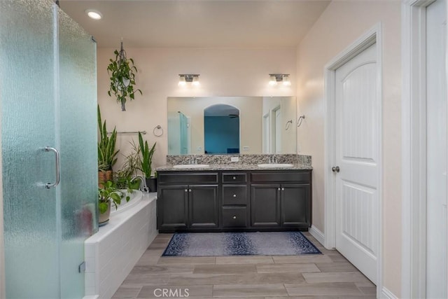 315 Timberline Way S, Madera, CA 93636 - full bathroom with double vanity, a bath, wood finished floors, a shower stall, and recessed lighting