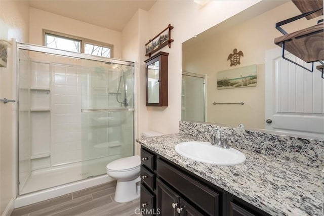 315 Timberline Way S, Madera, CA 93636 - full bathroom featuring a stall shower, wood finished floors, toilet, and vanity