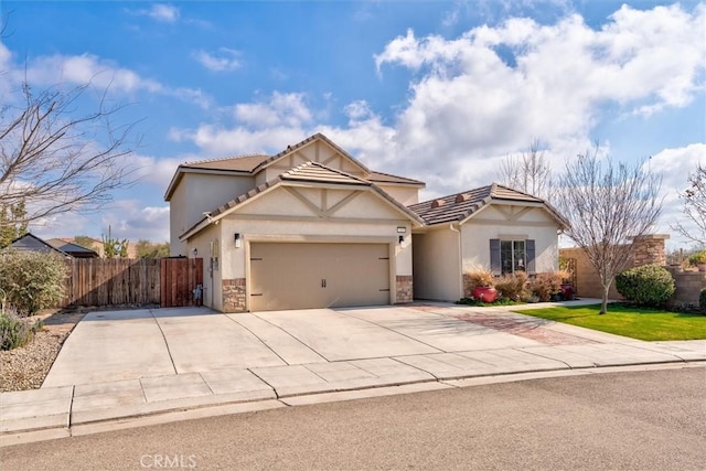 315 Timberline Way S, Madera, CA 93636 - view of front of property featuring an attached garage, stucco siding, concrete driveway, stone siding, and a tile roof