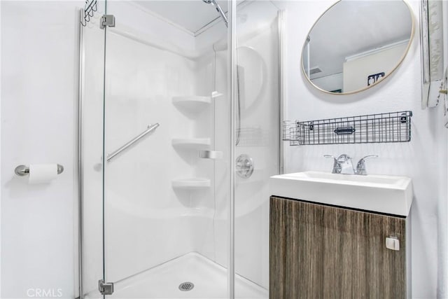 bathroom with vanity and a shower with door