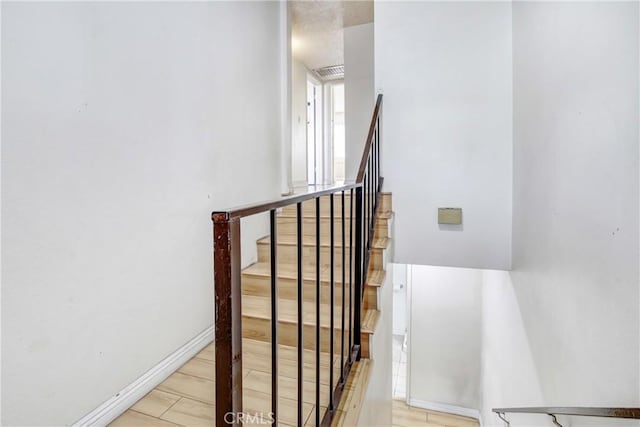 stairway with hardwood / wood-style flooring