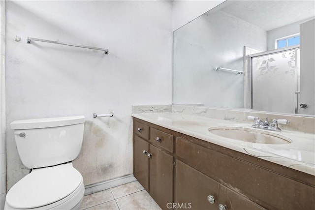 bathroom featuring tile patterned floors, toilet, a shower with shower door, and vanity