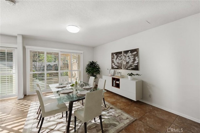 dining space with a textured ceiling