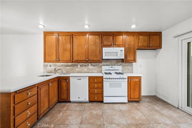 kitchen with tasteful backsplash, white appliances, sink, and light tile patterned floors