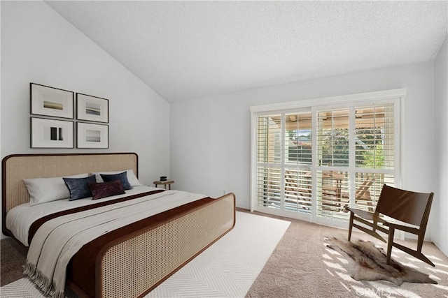 bedroom with carpet flooring, vaulted ceiling, a textured ceiling, and access to outside