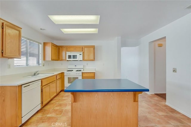 kitchen featuring a center island, sink, white appliances, and light tile patterned floors