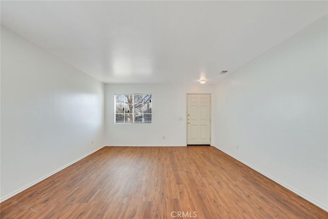 unfurnished room featuring wood-type flooring