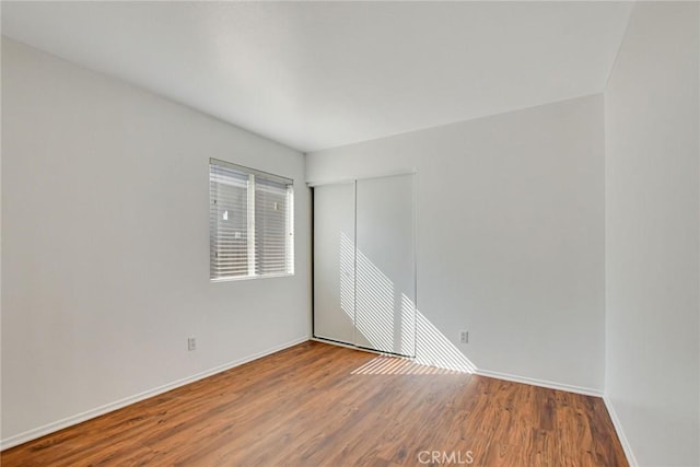 empty room with hardwood / wood-style floors