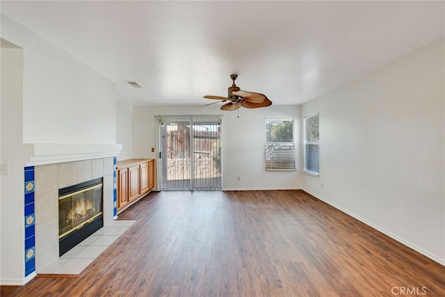 unfurnished living room with a fireplace, light hardwood / wood-style floors, and ceiling fan