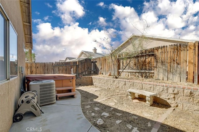 view of patio featuring a hot tub and central AC