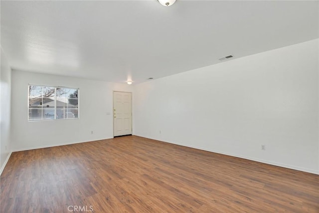 unfurnished room featuring hardwood / wood-style flooring