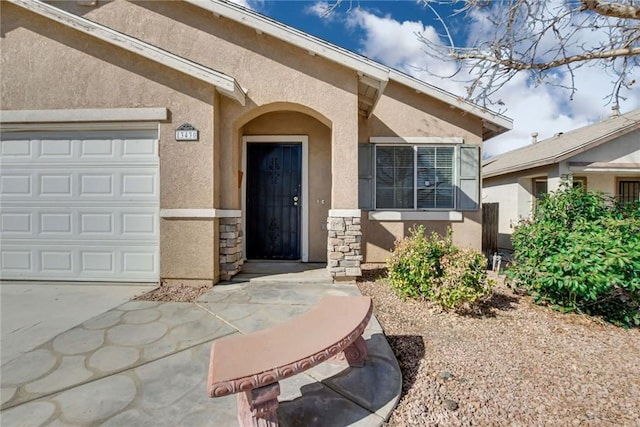 view of exterior entry featuring stone siding, stucco siding, and an attached garage