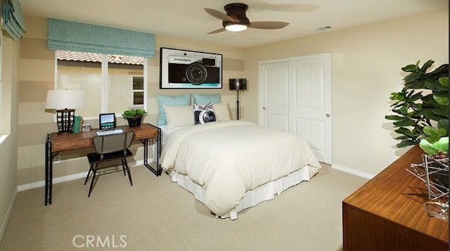 bedroom featuring light colored carpet and a closet