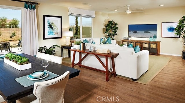 living room featuring hardwood / wood-style flooring and ceiling fan