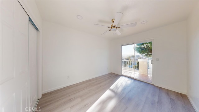 spare room featuring ceiling fan and light hardwood / wood-style floors