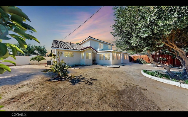 view of front of home with central AC and a patio area