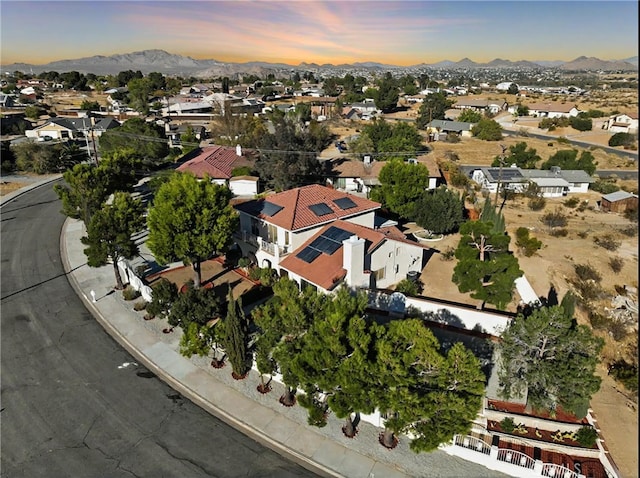 aerial view at dusk featuring a mountain view