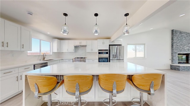 kitchen with white cabinets, stainless steel appliances, and sink