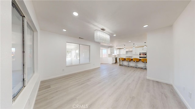 unfurnished living room featuring light wood-type flooring