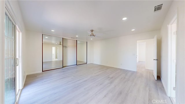 spare room featuring ceiling fan and light hardwood / wood-style flooring