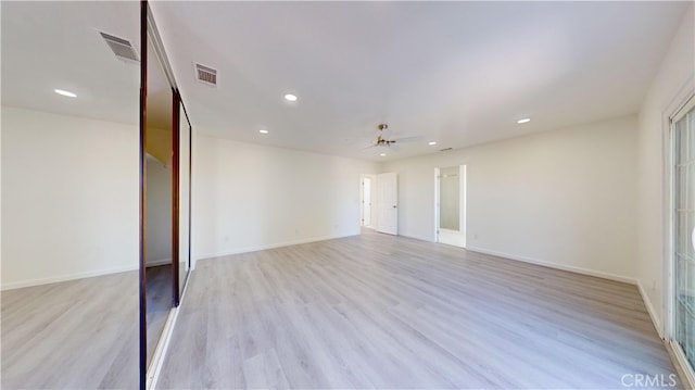 spare room featuring ceiling fan and light hardwood / wood-style flooring