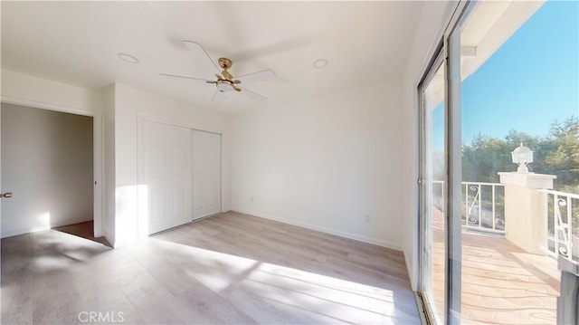 unfurnished bedroom featuring light wood-type flooring, a closet, access to exterior, and ceiling fan