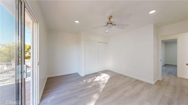 empty room featuring ceiling fan and light hardwood / wood-style flooring