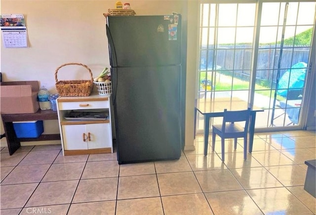 26302632 L St Unit A, B, C, Bakersfield, CA 93301 - kitchen with freestanding refrigerator, plenty of natural light, white cabinetry, and light tile patterned flooring