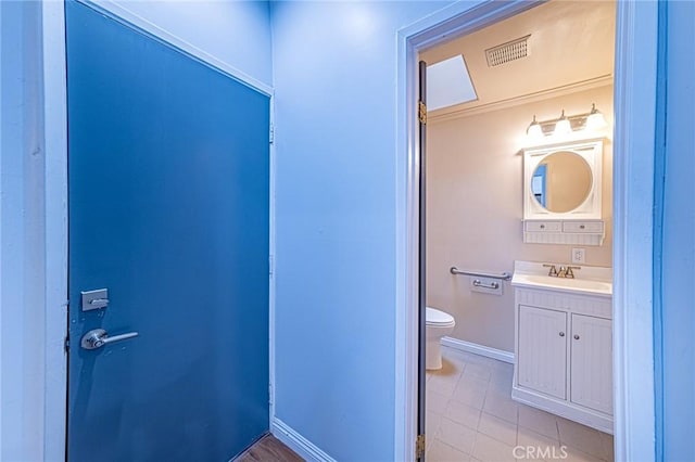 bathroom with tile patterned floors, vanity, and toilet