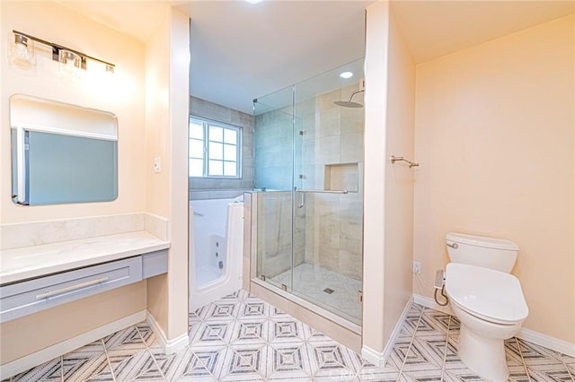 bathroom with vanity, toilet, and an enclosed shower