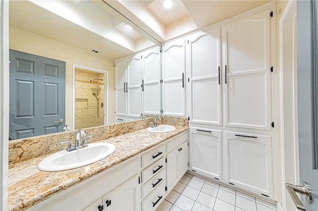 bathroom featuring vanity, tile patterned floors, and walk in shower