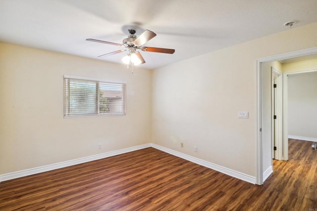 unfurnished room featuring dark wood-type flooring and ceiling fan