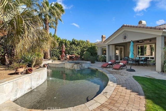 view of pool with an in ground hot tub, ceiling fan, and a patio area