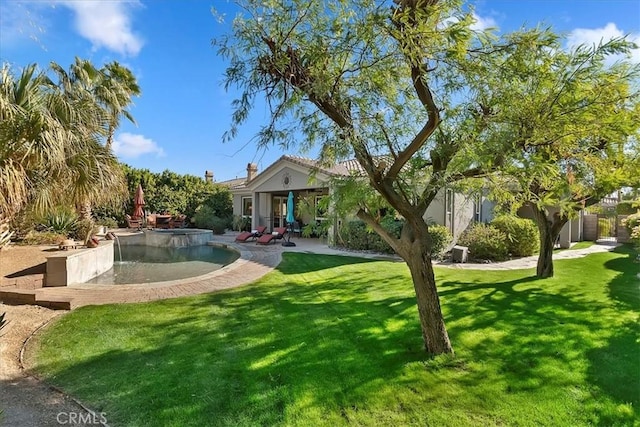 exterior space with a fenced in pool, a front lawn, and a patio