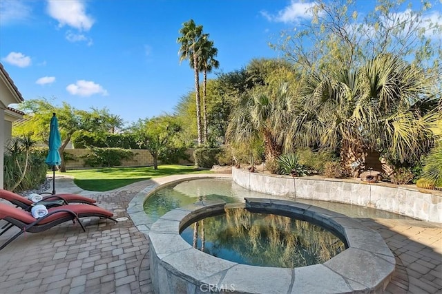 view of swimming pool with a yard and an in ground hot tub