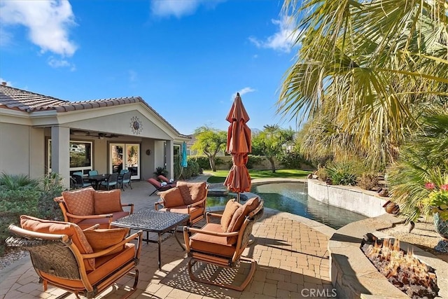 view of patio with an outdoor living space and ceiling fan