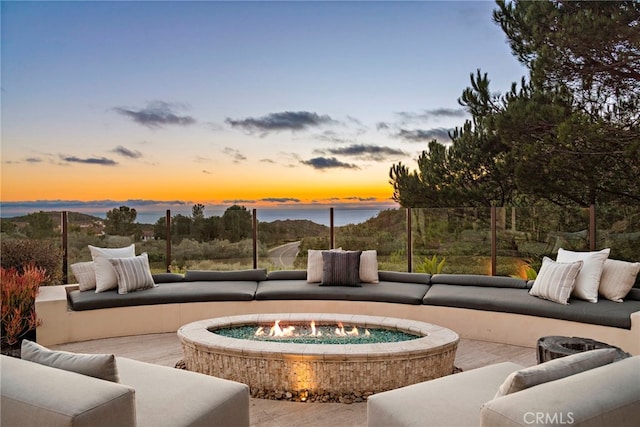 patio terrace at dusk featuring outdoor lounge area