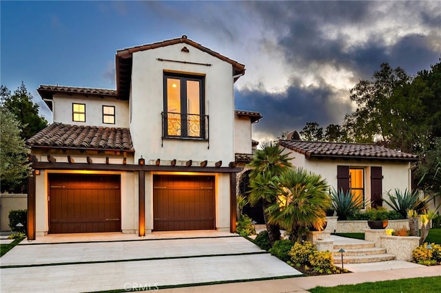 mediterranean / spanish-style home with a garage