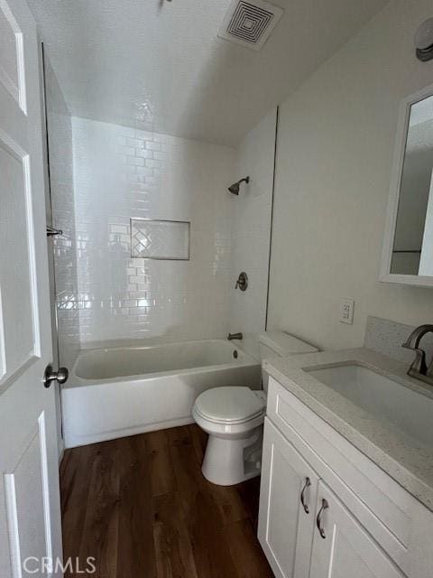 full bath featuring toilet, wood finished floors, visible vents, vanity, and  shower combination