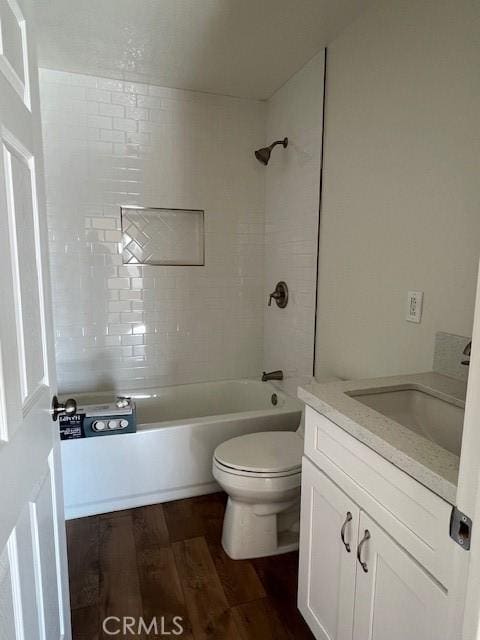 full bath featuring toilet, shower / tub combination, wood finished floors, and vanity